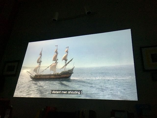 a three-masted sailing ship moving across a vast ocean
