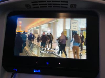 A man running towards us through a crowded airport
