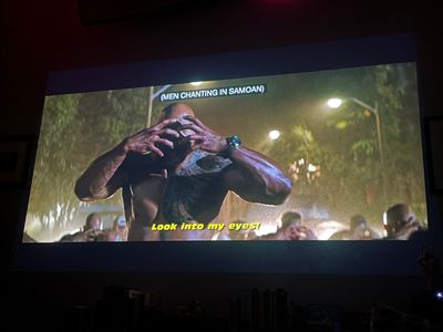 Look into my eyes! The Rock shirtless with hands clawed in front of his face, and men behind him making the same gesture
