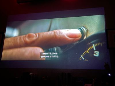 Forefinger of a hand pressing a button next to a dial gauge
